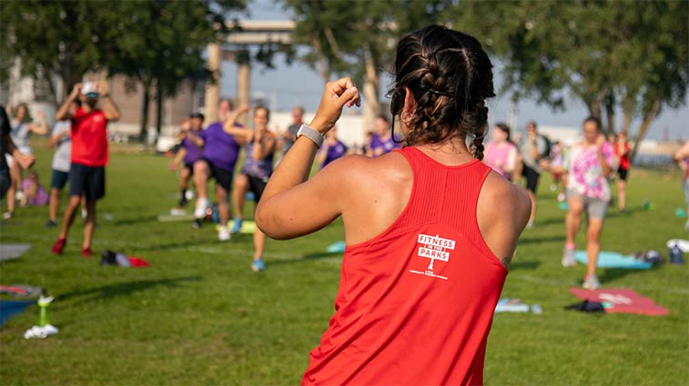 A woman instructing a Fitness in the Parks event