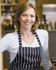 Woman making coffee in restaurant smiling