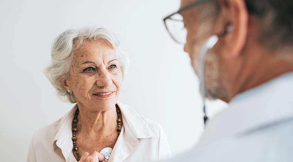 Woman getting her chest checked by a doctor
