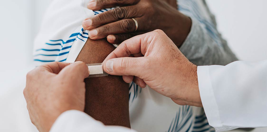 Patient having a band-aid applied to their arm